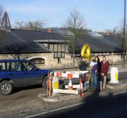 Fran Bryden, Mrs Laura James, and Councillor Ian Gilchrist at the crossing a few days after the accident. The big '4' indicates that this is the fourth accident here!